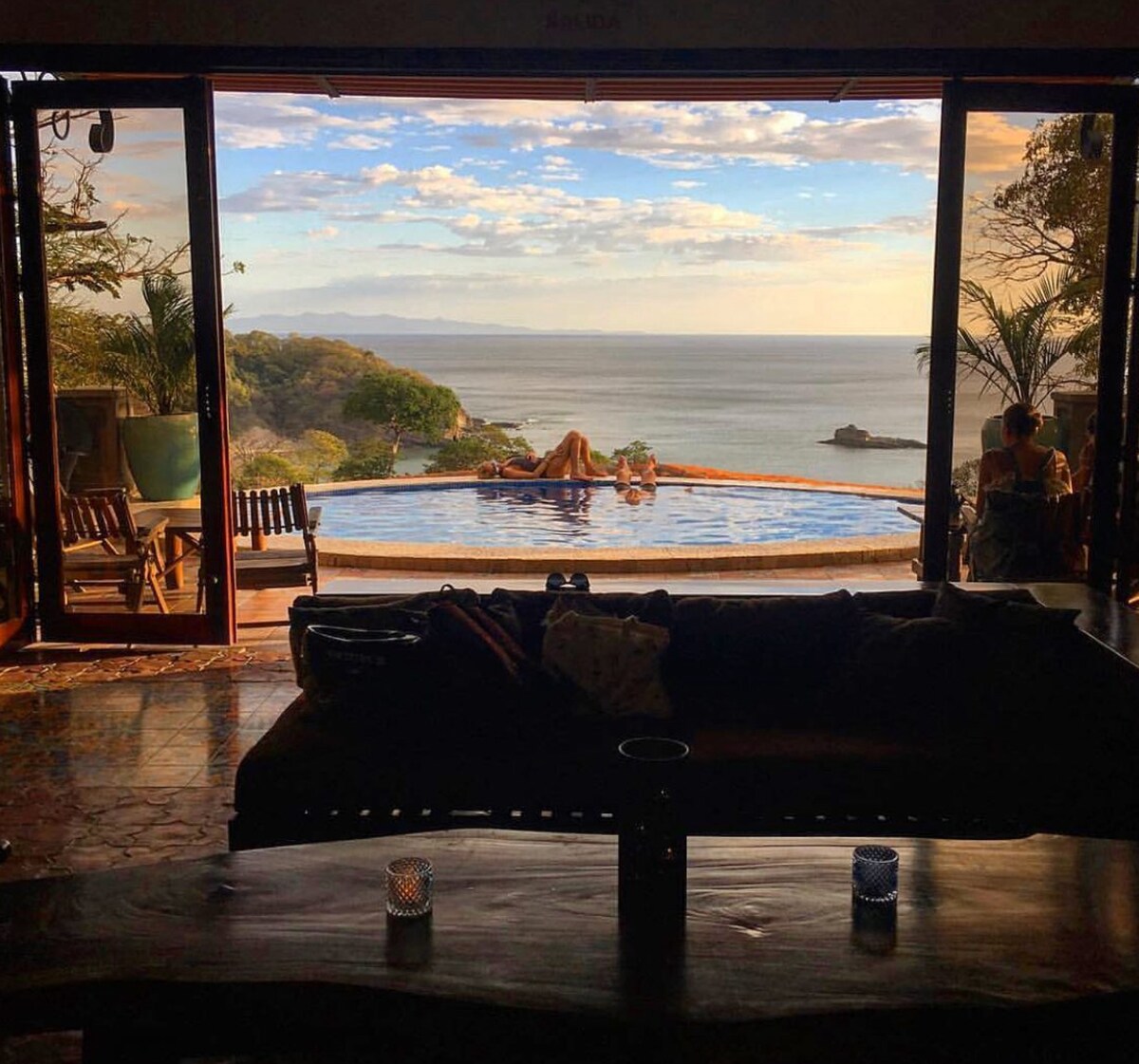 Ocean view from the villa's infinity pool above Playa Maderas at golden hour